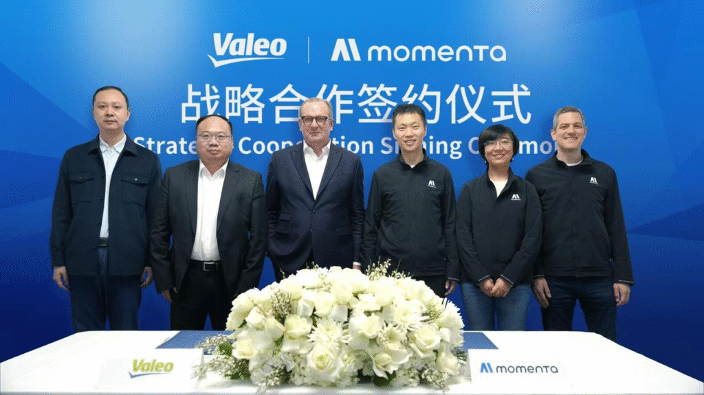 Executives from Valeo and Momenta at strategic partnership signing ceremony to jointly develop advanced driver assistance systems (ADAS) solutions.